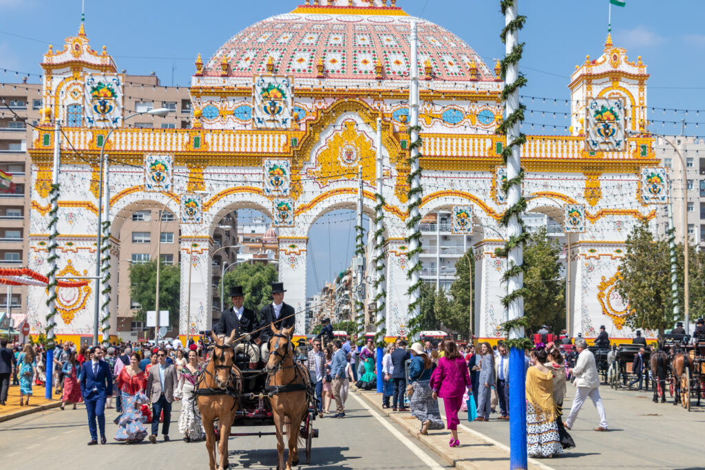 Feria de Abril in Sevilla, Eingang, Frauen in traditioneller Kleidung und Kutschen